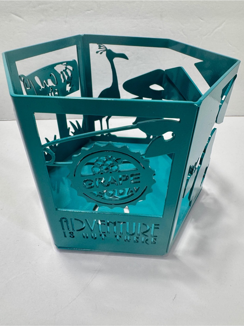 Handmade teal-colored, laser-cut candle holder inspired by the Pixar film Up.